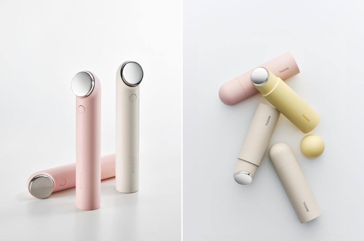 Pastel pink, cream and yellow cylindrical devices are arranged on a white background.