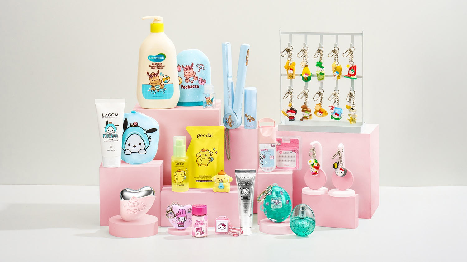 Skincare, toiletries and character-themed accessories arranged on pink display blocks.