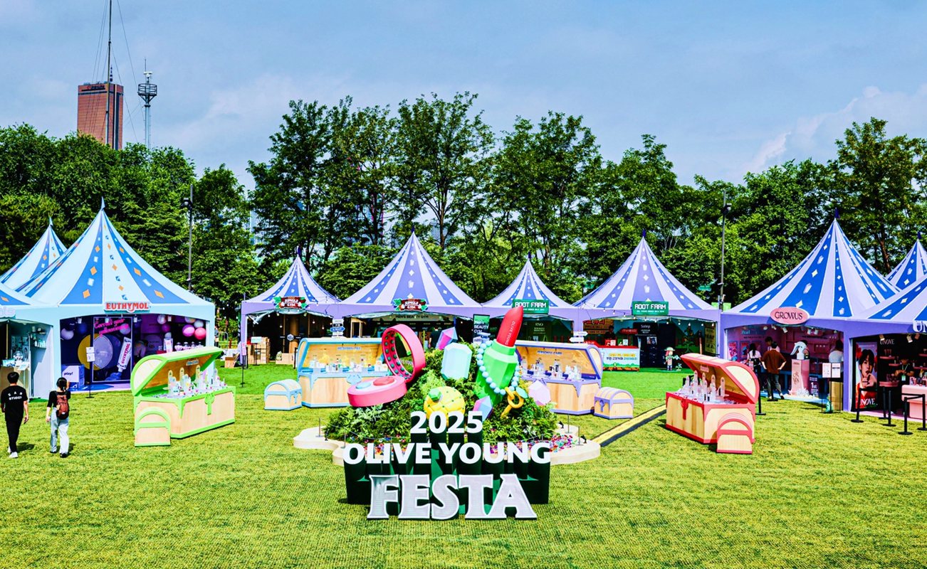 Colorful tents and product booths fill a lawn at the 2025 Olive Young Festa.
