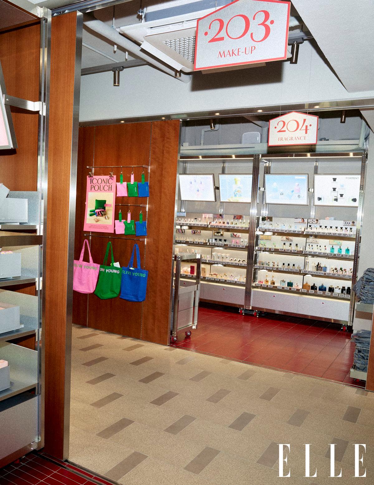 A cosmetics shop displays makeup and fragrance shelves beneath signs labeled 203 and 204.