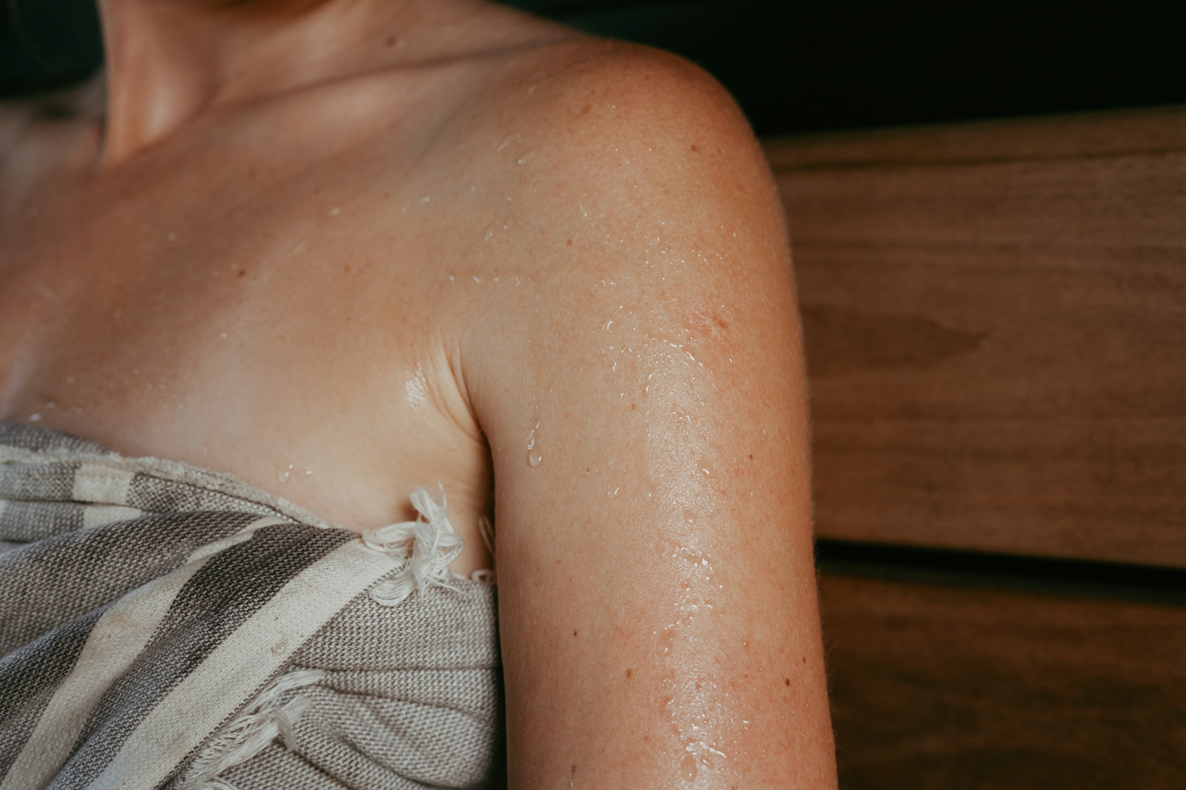 Close-up of a person's upper body while sitting in a sauna