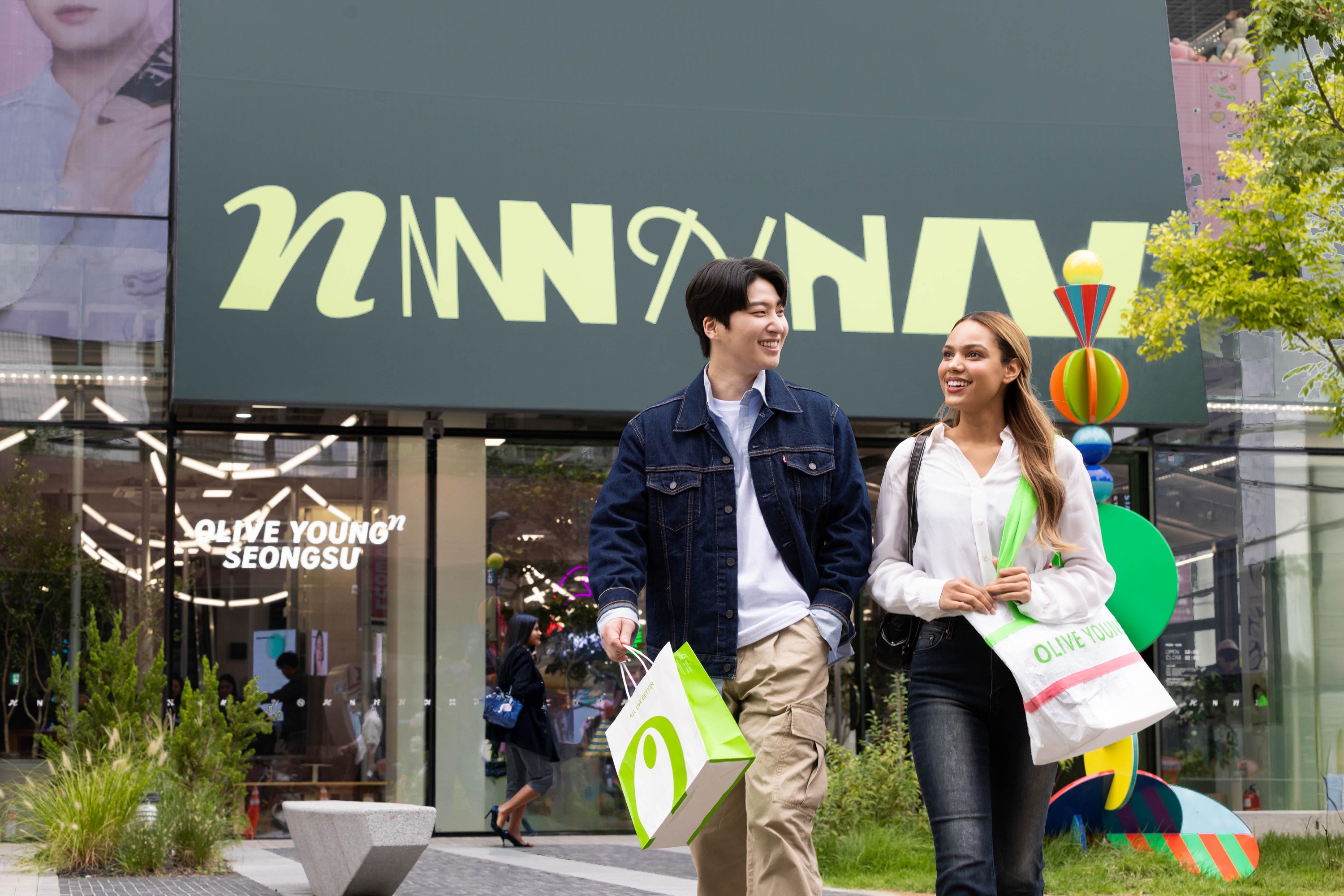 Foreign tourists leave the 'Olive Young N Seongsu' store after shopping