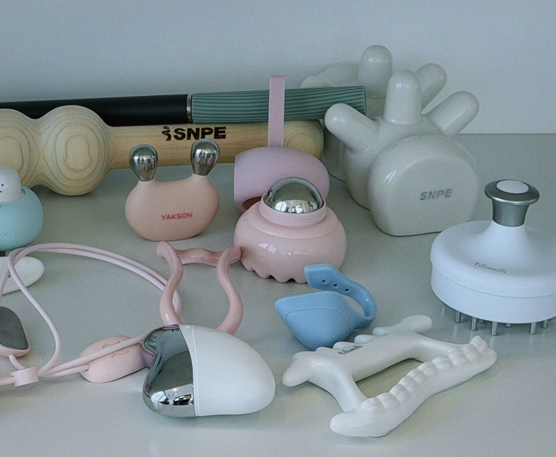 Various personal-care devices and accessories are arranged on a tabletop.